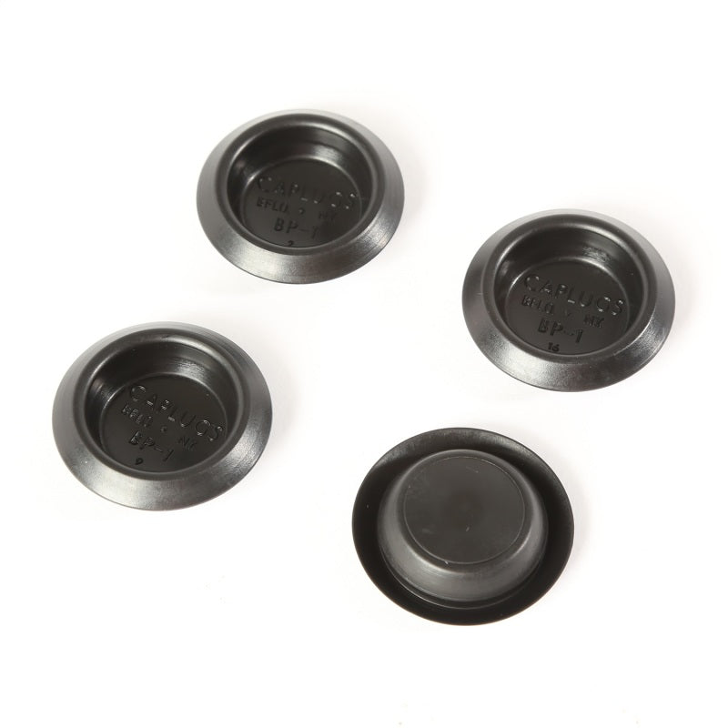 Four black 1-inch rubber floor pan drain plugs for Jeep CJ7 and Scrambler models.