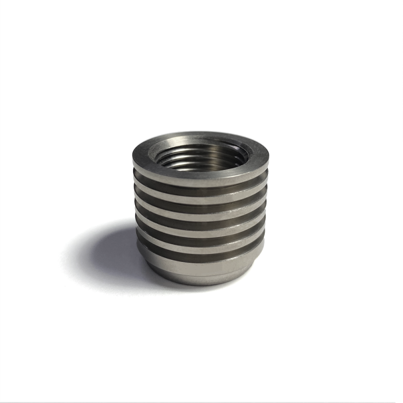 Titanium O2 sensor bung featuring integrated heat sink cooling fins and M18x1.5 threads for exhaust mounting.