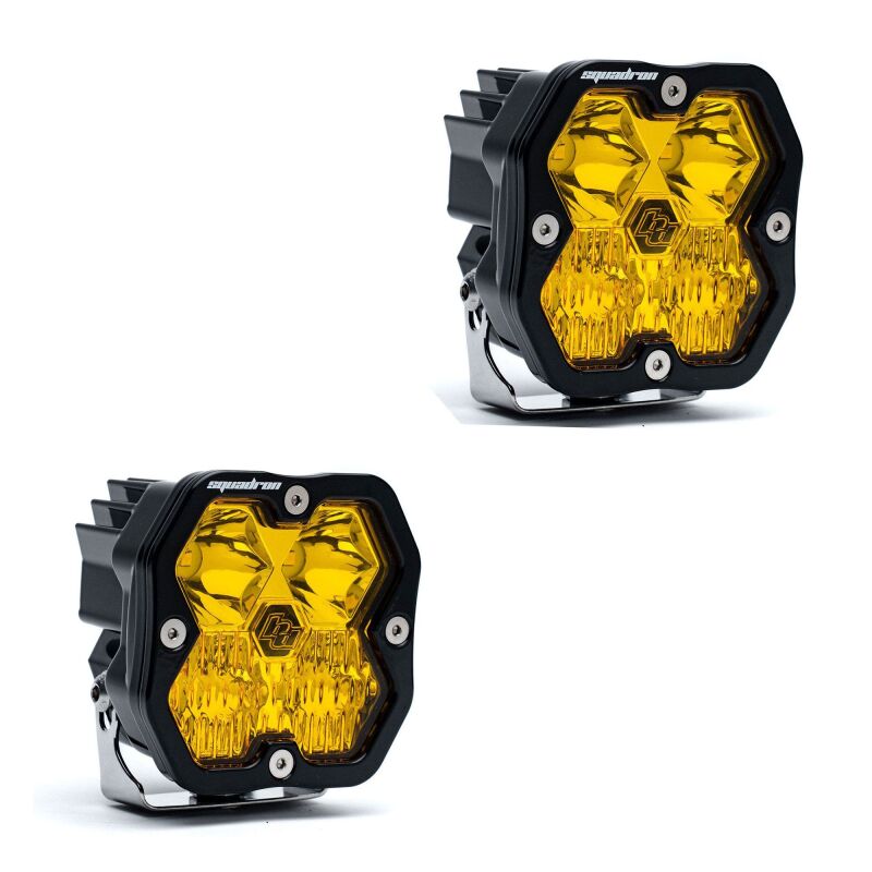 Pair of square Baja Designs Squadron Sport LED lights with black housings and translucent amber lenses.