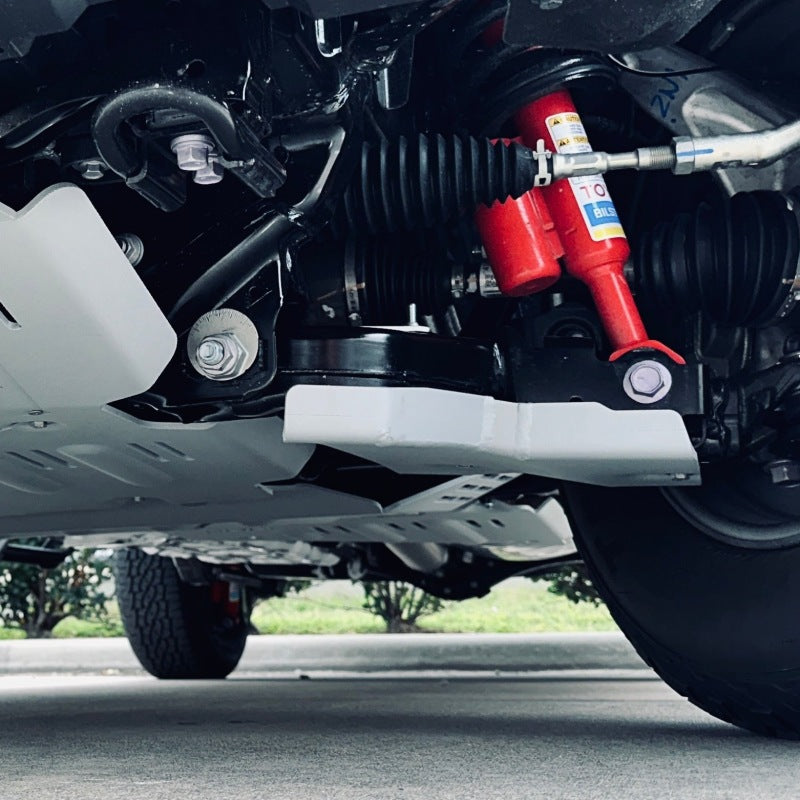 Matte metallic silver Rival 1/4-inch aluminum lower control arm skid plates for 2024-2025 Toyota Tacoma.