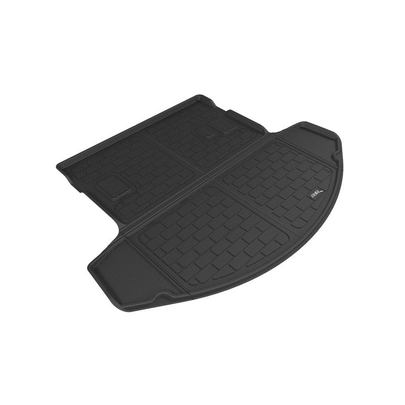 Black 3D MAXpider Kagu series cargo liner with carbon fiber texture and raised edges for vehicle trunk protection.