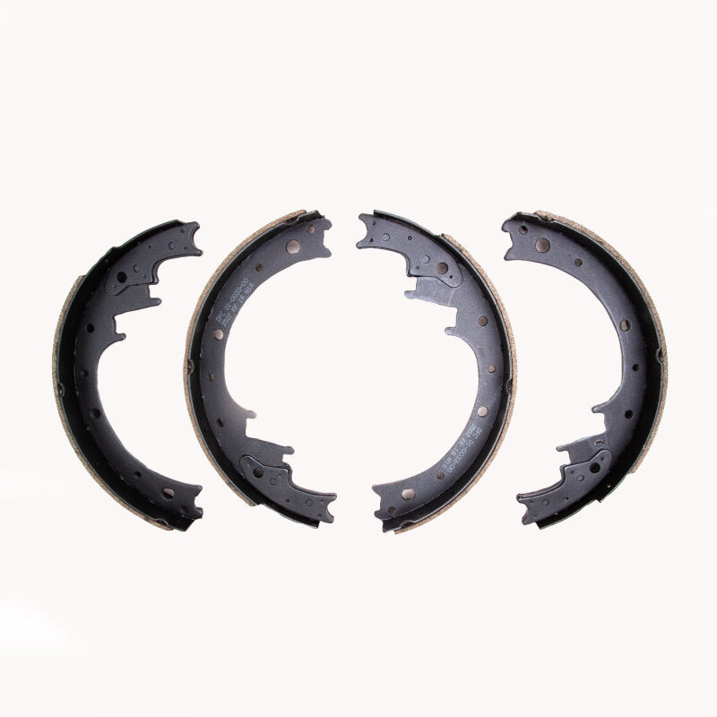 Black anti-rust coated semi-metallic brake shoes with precision ground friction material and new carbon steel backing.