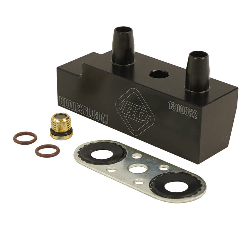 BD Diesel aluminum transmission cooler bypass delete block with replacement seals and a magnetic service plug.