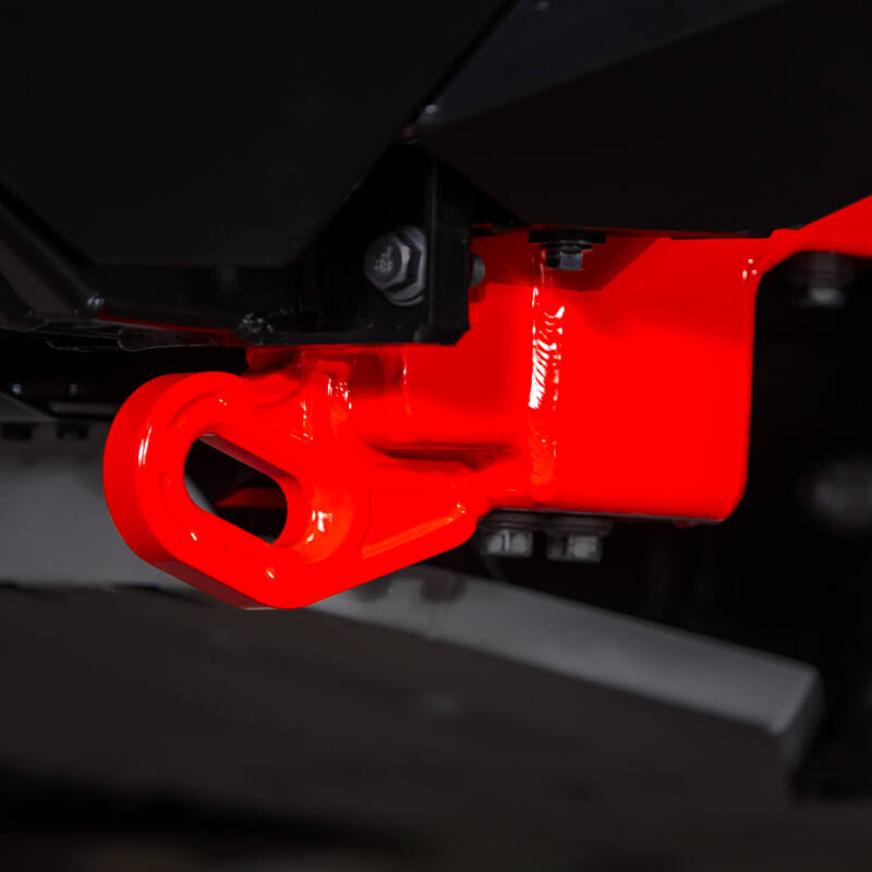Red powder-coated forged steel ARB recovery point mounted to a Toyota Land Cruiser frame rail.