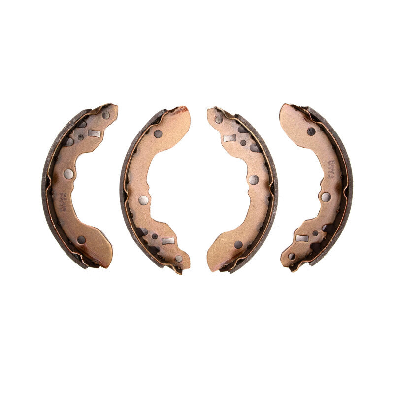 Set of DFC Premium Service rear brake shoes with black anti-rust coating and semi-metallic friction material.