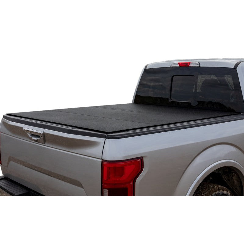 Access LOMAX black hard tri-fold tonneau cover installed on a 2022-2025 Nissan Frontier with 5ft bed