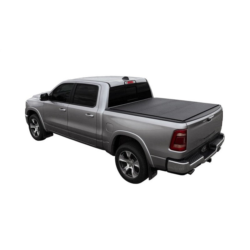Access LOMAX black urethane hard tri-fold tonneau cover installed on a Ram 1500 truck bed with a 5' 7" box.