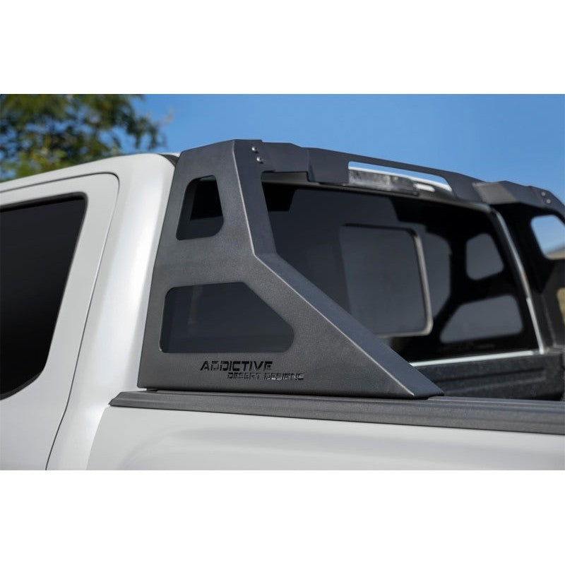 Hammer black Addictive Desert Designs Stealth Fighter chase rack with 50-inch light bar mount for 2009-2025 Ford F-150.