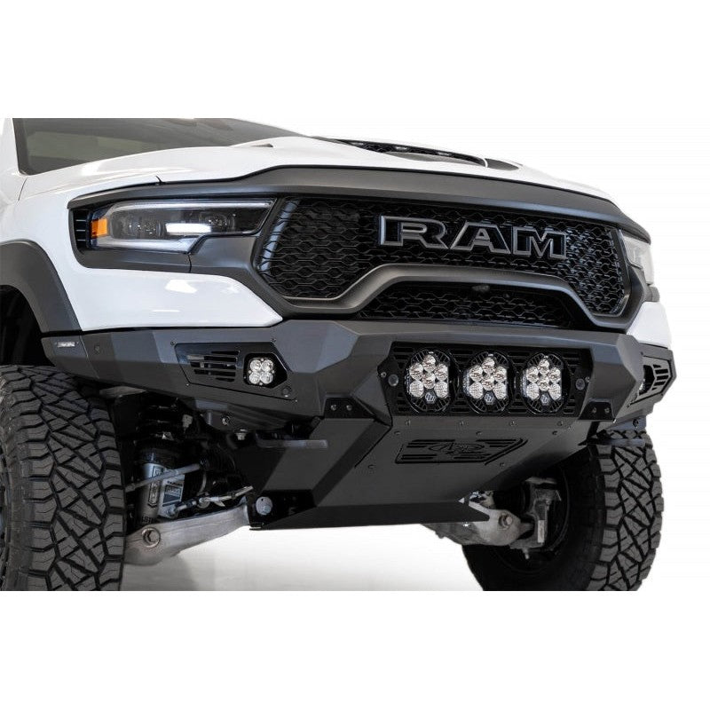 Hammer Black Addictive Desert Designs Bomber front bumper with aluminum skid plate on a Ram 1500 TRX.