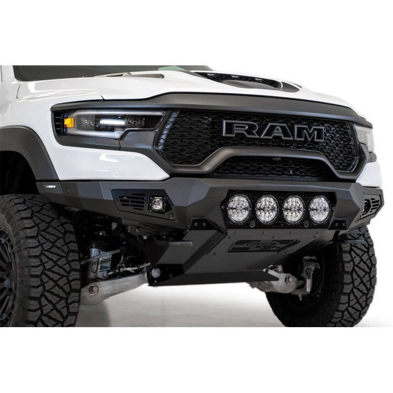 Hammer Black Addictive Desert Designs Bomber front bumper with aluminum skid plate on a 2021-2024 Ram 1500 TRX.