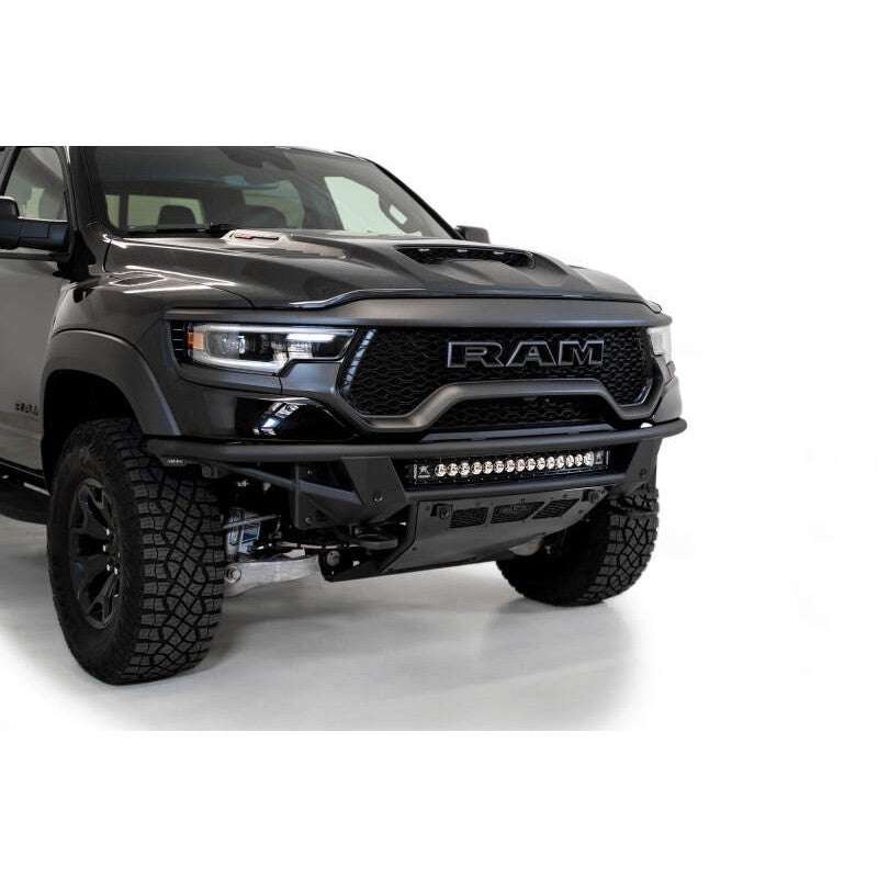 Hammer Black ADD Offroad PRO Bolt-On front bumper for Ram 1500 TRX with parking sensor cutouts and vented aluminum skid plate.