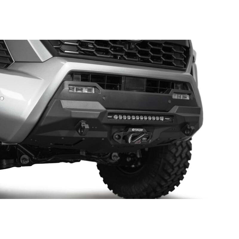 Addictive Desert Designs Stealth Series center mount winch front bumper in hammer black for 2024-2025 Toyota Tacoma.
