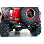 Hammer black Addictive Desert Designs Bomber rear bumper with satin black panels and sensor cutouts for Ford Bronco.