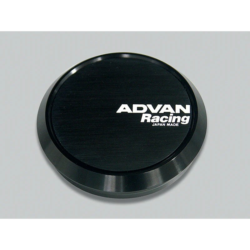 Close-up of a round, flat black Advan wheel center cap with 73mm diameter