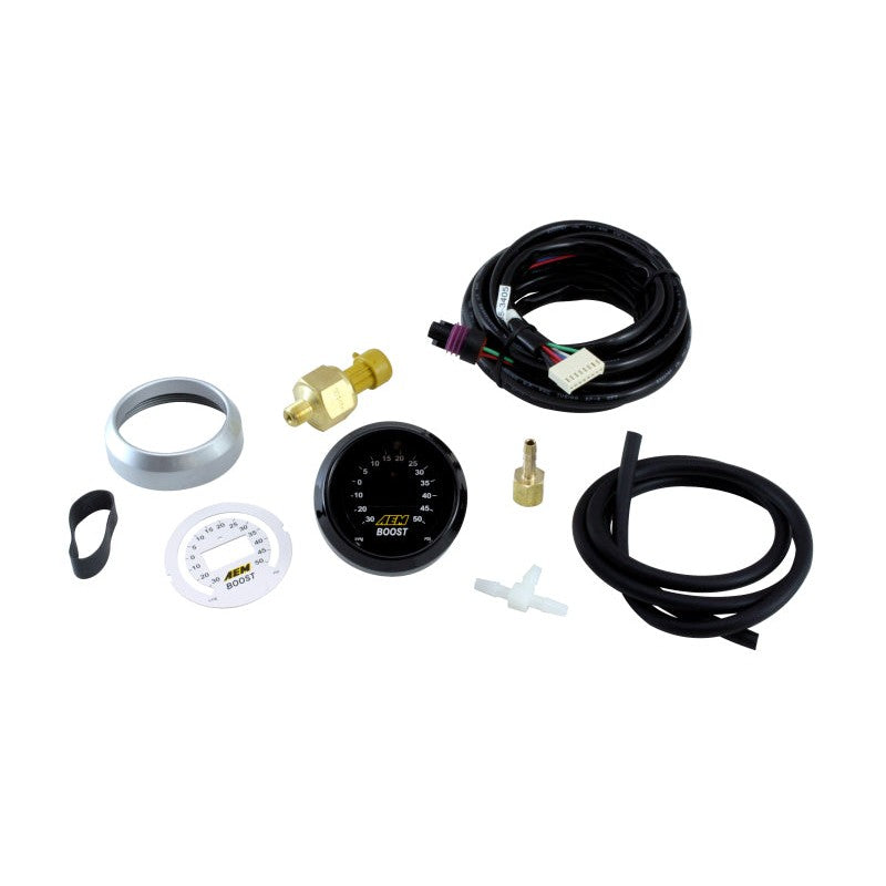 AEM 52mm digital boost gauge kit with interchangeable faceplates, silver and black bezels, and brass hardware.