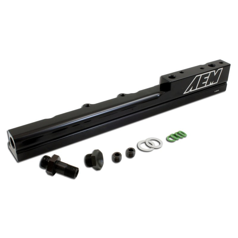 Black anodized AEM CNC machined billet aluminum high volume fuel rail with laser engraving and 1/8 NPT port.