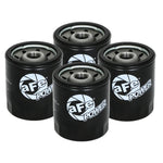 Four aFe Power ProGuard HD black steel canister oil filters featuring integrated 3/8 inch ratchet drive removal bosses.