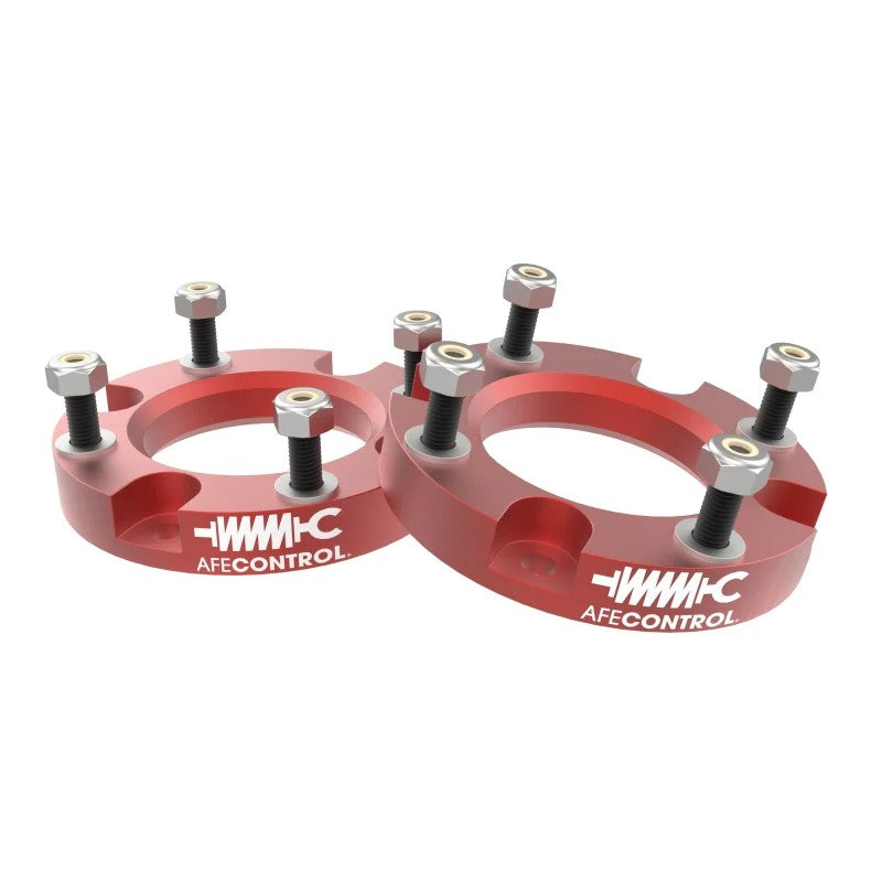 Red anodized aFe CONTROL 1.5-inch CNC-machined aluminum front leveling spacers for 2024-2026 Toyota Tacoma.