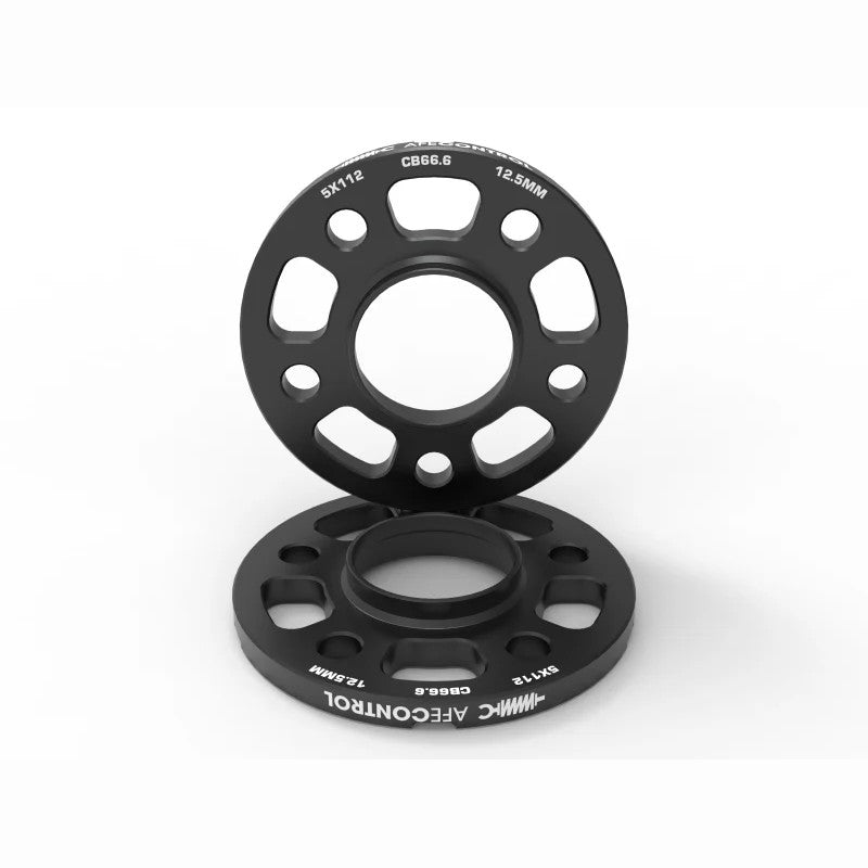 Black anodized aFe CONTROL 12.5mm billet aluminum wheel spacers with 5x112 bolt pattern and integrated pry pockets.