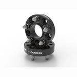 Pair of black anodized aFe CONTROL 1.25-inch hub-centric wheel spacers with studs and lug nuts.