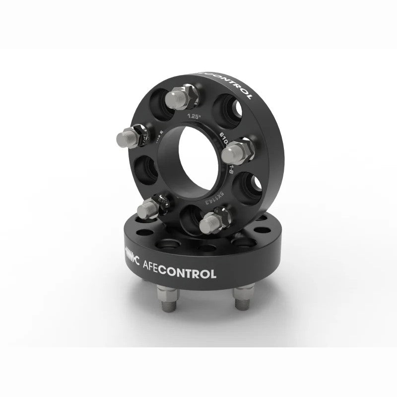 Pair of black anodized aFe CONTROL 1.25-inch hub-centric wheel spacers with studs and lug nuts.