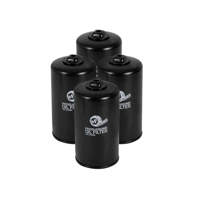 Four aFe Pro GUARD D2 white oil filters featuring integrated 3/8 inch ratchet drive for Ford 6.7L diesel trucks