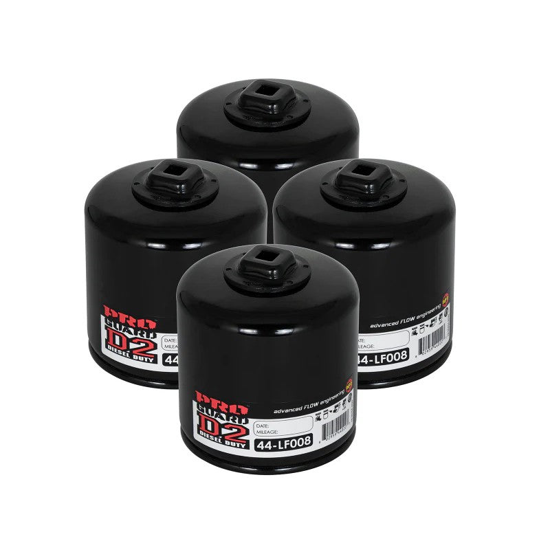 Four aFe POWER Pro GUARD D2 white oil filters with black branding and heavy-duty canisters.