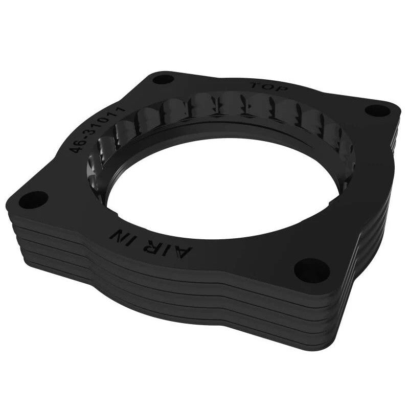 Black anodized aFe Silver Bullet throttle body spacer for BMW N52 engines featuring a serrated helix bore.