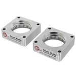 Pair of aFe Silver Bullet 6061-T6 billet aluminum throttle body spacers for Nissan and Infiniti V6-3.7L engines.