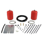 Red molded polyurethane Air Lift 1000 air springs with installation hardware and air lines for coil spring suspension.