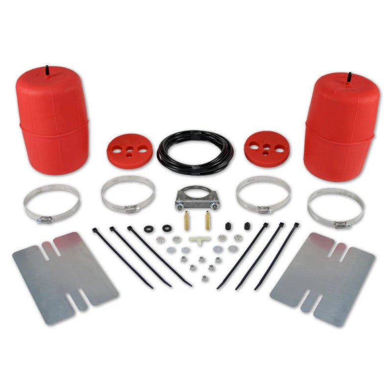 Two red cylindrical polyurethane air helper springs with air line tubing and installation hardware.