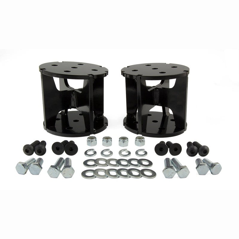 Black powdercoated 4-inch angled steel air spring spacer for lifted truck suspension