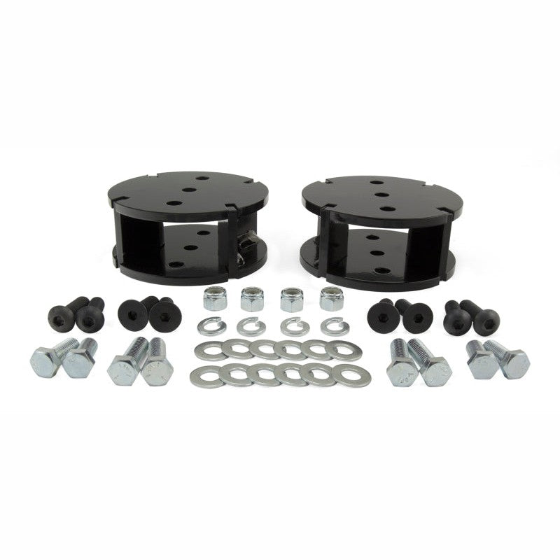 Black powdercoated 2-inch level air spring spacer for Air Lift LoadLifter series with spinal mounting hardware.