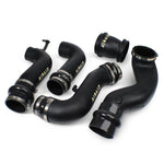 Airaid high-density polyethylene modular intake tube with stainless steel clamps and silicone couplers.