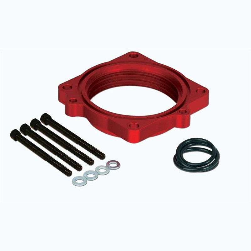 Airaid PowerAid throttle body spacer featuring the patented Helix Bore design with included gaskets and hardware.