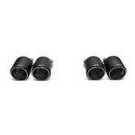 Set of four Akrapovic carbon fiber exhaust tail pipes featuring a matte carbon finish and engraved logos.