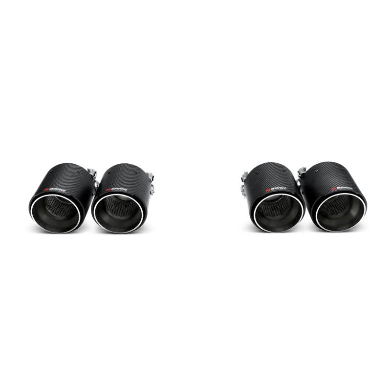 Set of four Akrapovic carbon fiber exhaust tail pipes featuring a matte carbon finish and engraved logos.