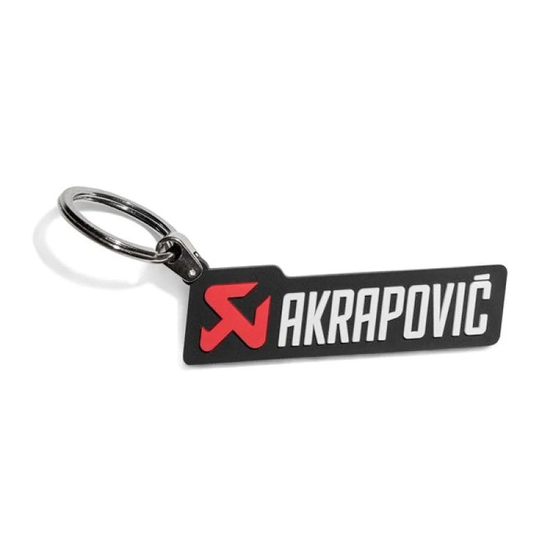 Akrapovič horizontal logo keychain made of flexible black and red rubber to prevent scratches on vehicle surfaces.