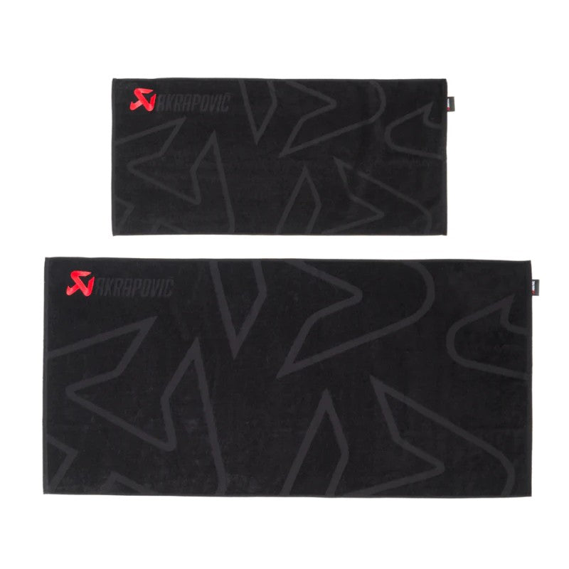 Black Akrapovic cotton towels with red embroidered logos and an 8 liter black waterproof dry bag.