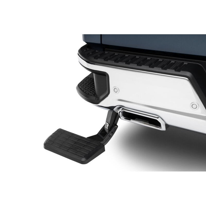 Black AMP Research retractable BedStep bumper step for 2019-2026 Chevrolet Silverado and GMC Sierra 1500 trucks.