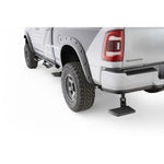 Black AMP Research BedStep retractable rear bumper step showing glass-reinforced composite non-slip pad.
