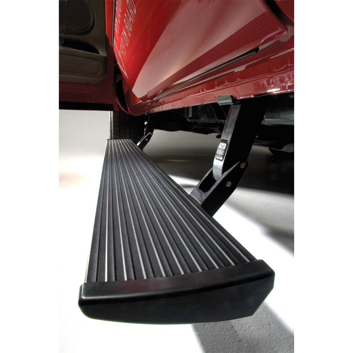 Black AMP Research PowerStep electric running board with integrated LED lighting and mounting hardware.