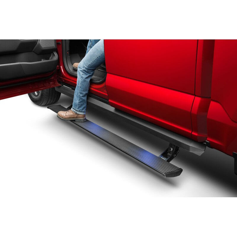 Black AMP Research PowerStep XL electric running board with integrated rocker rail and LED illumination.