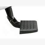 Black retractable AMP Research BedStep mounted to a truck's rear frame under the bumper.