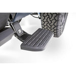 AMP Research BedStep2 black retractable side step for truck bed access on a Ram 2500 frame