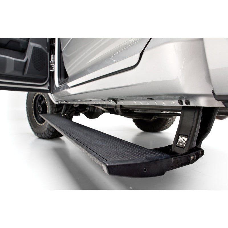 Retractable AMP Research PowerStep XL electric running boards with integrated LED lights for Ford F-150.