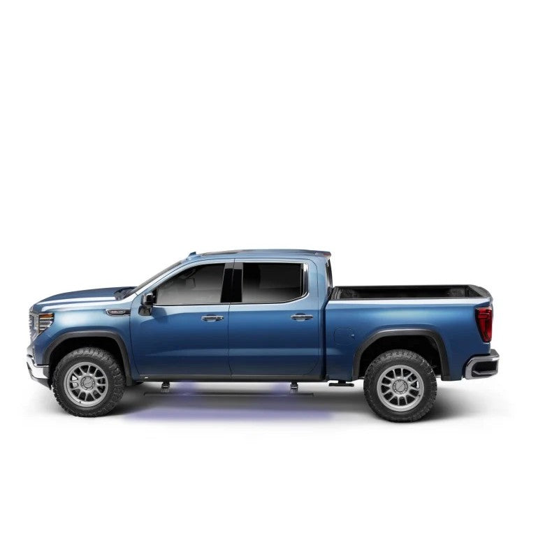 AMP Research PowerStep electric running boards with integrated LED lighting deployed on a GMC Sierra truck.