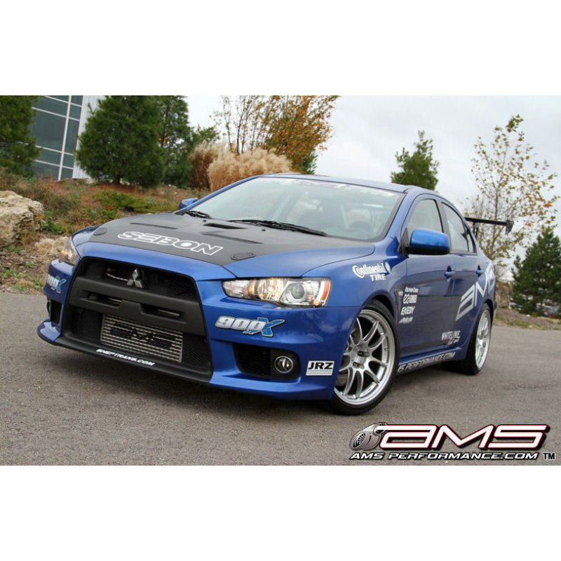 Silver AMS Performance front mount intercooler with black stenciled logo and cast end tanks for Mitsubishi Evolution X.
