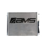 AMS Performance heat exchanger for BMW G8X M2/M3/M4 S58 engine, featuring black logo on aluminum core.