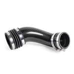 Glossy carbon fiber turbo inlet pipe with a black silicone flex coupler and mounting hardware.
